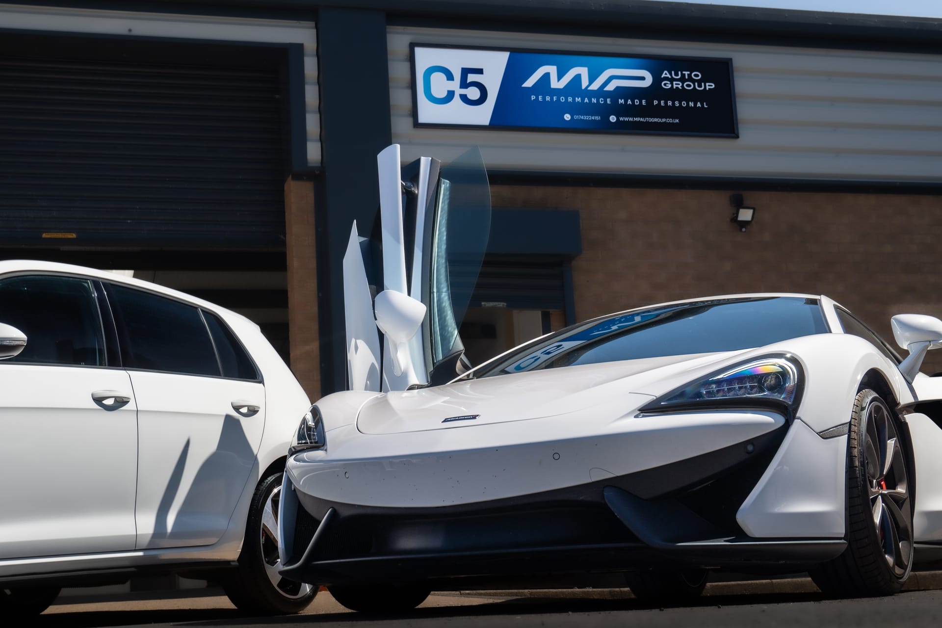 A McLaren 570S with its doors up outside the MP Auto Group unit